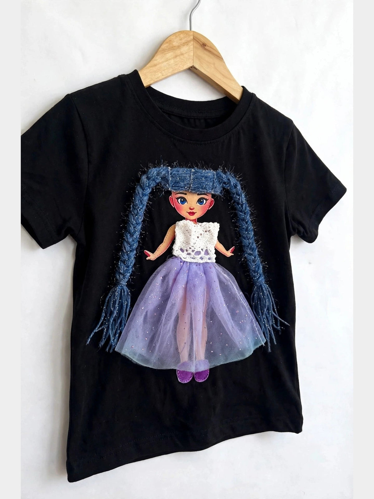 Black doll T-shirt with blue-haired doll in purple skirt, alternate product photo