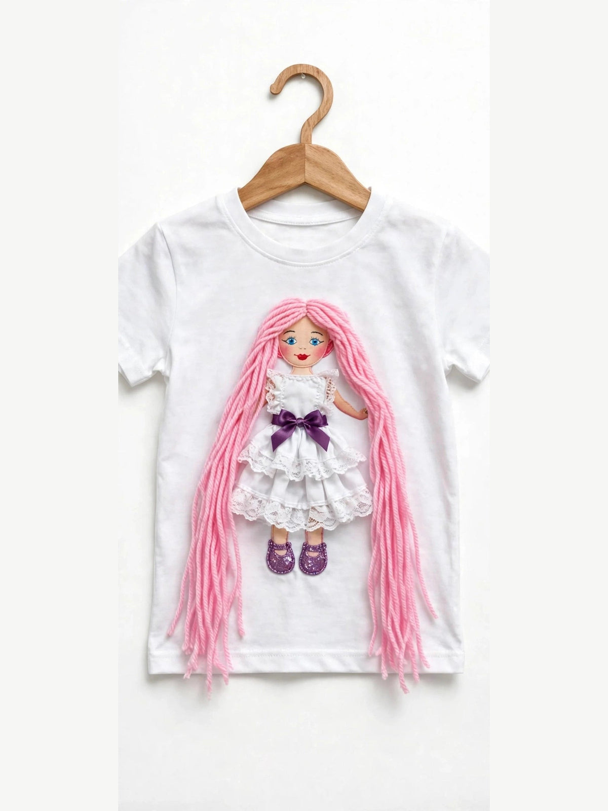 White T-shirt with handmade doll appliqué, pink yarn hair and white ruffle dress