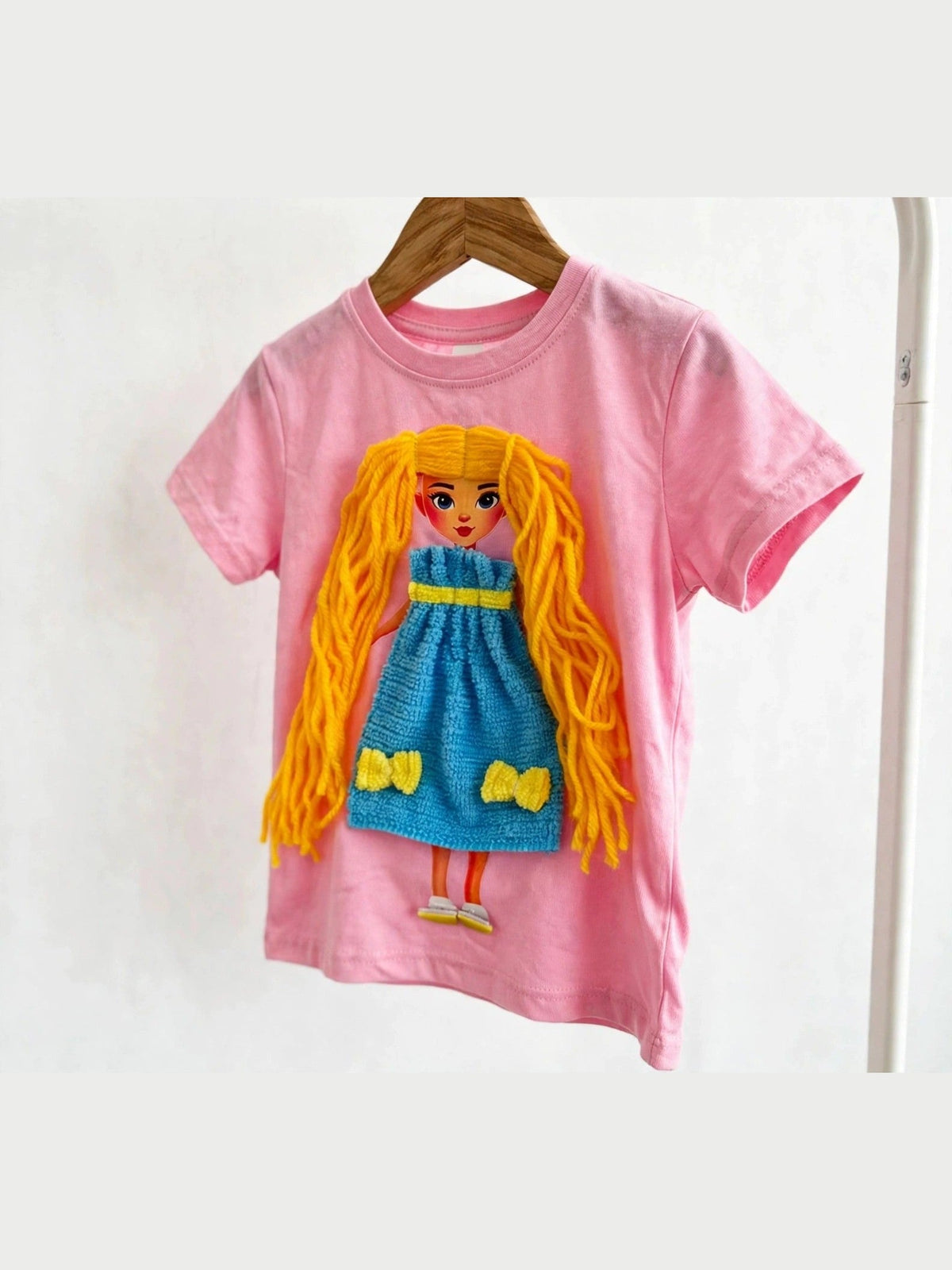 Pink doll T-shirt with yellow-haired doll in blue dress, alternate product photo