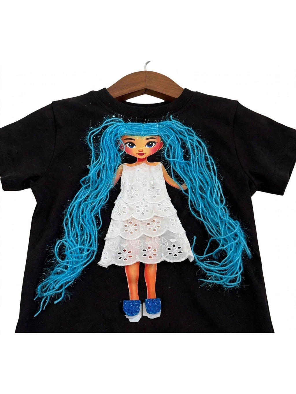 Handmade blue hair doll design in eyelet dress on black T-shirt, product photo