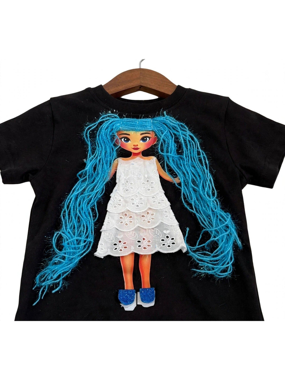 Handmade blue hair doll design in eyelet dress on black T-shirt, product photo