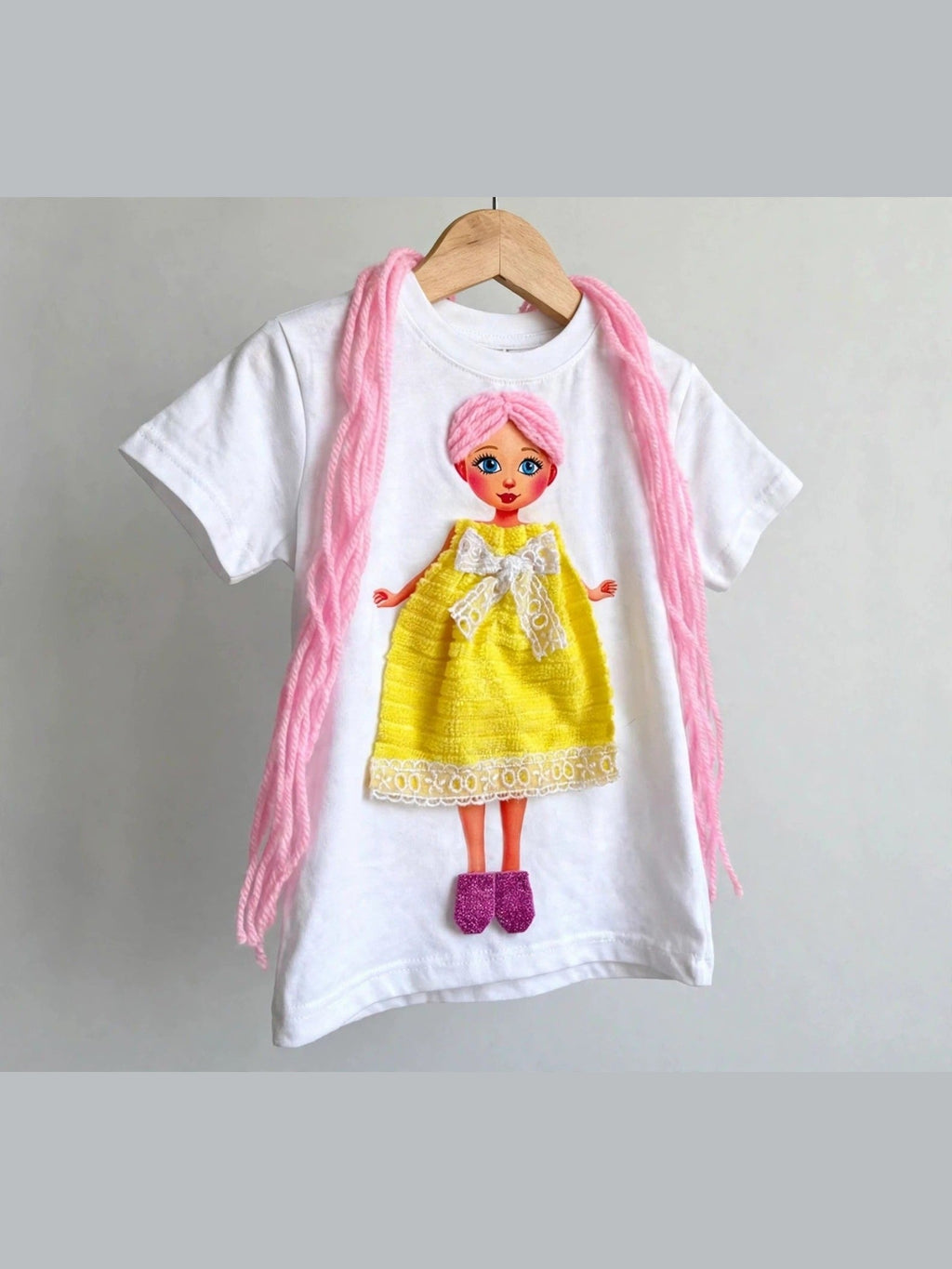 White doll T-shirt with pink-haired doll in yellow dress, alternate product photo